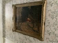 Artwork hanging on a wall with floral wallpaper, showing the full framed print from an angle.