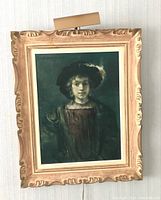 Framed print of a young woman in historical costume with feathered hat and light fixture above.