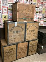 Six stacked wooden shipping crates featuring Kertamanah BOP stenciled markings and weight information on five crates.