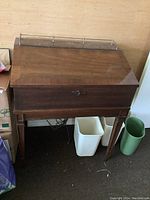 Full view of closed wooden secretary style cabinet housing the stereo system