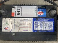 Top view of the AAA 12V battery showing labels with battery specifications and Maxsold auction sticker.