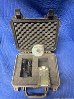 Open black Pelican case containing MSA Altair gas detector, charger, and manual.