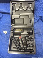Closed carrying case showing impact wrench and four sockets with attached power cord.