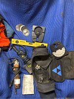 Wide shot of lot showing grinder, multi cutter, discs, level, cases, manual, and cords.