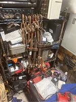 Front view of the black metal wire rolling shelf rack filled with various items (not included).