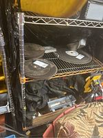 Photo showing metal rolling rack with various workshop items stored on shelves, contents not included in sale.