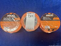 Three new rolls of orange AM600 vinyl tape by Agent, 3 inches wide and 108 feet long each, with packaging labels visible.