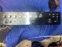 Top front view of TOA 900 Series amplifier showing multiple control knobs and switches on a black metal faceplate.