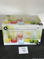 Box front showing 12 piece acrylic drinkware set with colored glasses and illustrated citrus fruits.