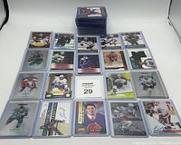 Photo showing 26 hockey cards laid out in protective sleeves, some with autographs and patches