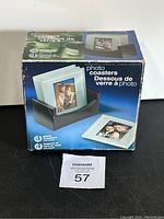 Box showing set of 4 glass photo coasters with holder and product information
