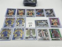 Top view of 14 soccer cards featuring players mostly from Bundesliga clubs, displayed in protective plastic sleeves.