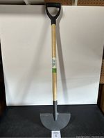 Full view of D-handled turf edger with wooden handle and half-moon steel blade