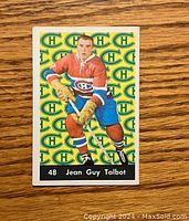 Front of the 1961-62 Parkhurst hockey card showing player Jean Guy Talbot in Canadiens uniform with logo patterned background.