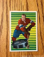 Front of 1963-64 Parkhurst hockey card showing Claude Provost in Canadiens uniform with green and yellow striped background and puck graphic.