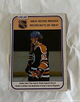 Front side of the 1980-81 O-Pee-Chee Wayne Gretzky hockey card featuring a photo of Gretzky and record-breaking stats.