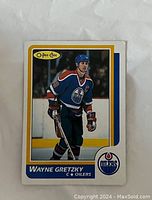 Front of 1986-87 O-Pee-Chee Wayne Gretzky hockey trading card #3 showing player image and Oilers emblem.