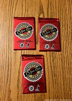 Front view of three sealed 1992-93 OPC Premier Hockey packs in red foil with logo and branding