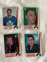 Front view of four 1969-70 O-Pee-Chee hockey cards of Paul Henderson, Reg Fleming, Orland Kurtenbach, Jim Neilson showing players' images and team names.