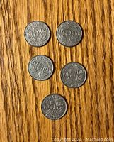 Five Canadian 5 cent coins showing denomination side, dated 1922 with maple leaf decoration.