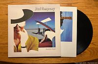Front cover of Bad Company's Desolation Angels vinyl record with record partially shown