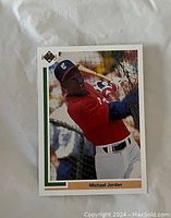 Front of the card showing Michael Jordan in batting pose wearing red Chicago White Sox uniform.