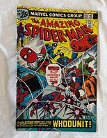 Front cover of The Amazing Spider-Man #155 showing colorful Marvel comic cover artwork with Spider-Man and other characters, highlighting a whodunit storyline.