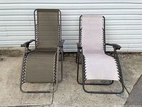 Similar photo angle showing the two chairs with visible armrests and frame details.