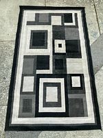 Second angle of the same Canadian machine made geometric rug showing consistent pattern and condition.