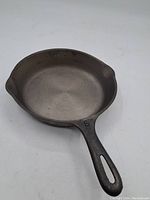 Another angle of the cast iron fry pan highlighting texture and handle design.