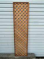 Second frontal photo of the cedar lattice panel for clarity and detail, showing wear and natural wood finish.