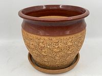 Alternate view of the planter highlighting the pottery body and saucer.