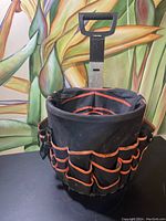 Another image of the same tool and garden carrier from the same angle, highlighting the construction and pockets for tools.