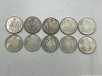 Ten Canadian 50 cent coins laid out in two rows on white background, coat of arms side up