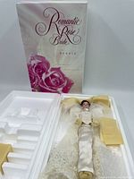 Full view of the Romantic Rose Bride Barbie doll in original box with foam inserts and box cover showing pink roses and text.