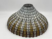 Side view showing the overall dome shape with white and amber stained glass in geometric pattern.