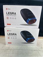 Two Lifepro Legra Hand Massagers in original white boxes with product image and branding visible.
