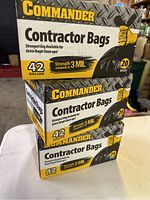Stack of three unopened Commander Contractor Bags boxes on a white surface, showing front and side packaging details