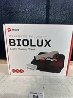 Front of the white and orange Lifpro Biolux Light Therapy Wand box showing product name and image of the wand and carrying case.