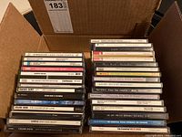 Photo showing a box filled with various music CDs including multiple Celine Dion albums and other artists.