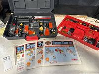 Overview of Steel Tec Harley Davidson construction kit parts in organizer trays with instruction manuals laid out below.