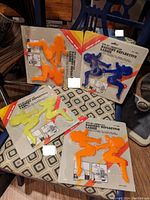 Photo showing all four ladies silhouette fender reflectors in original packaging, arranged in a cluster on a chair.