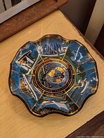 Photo showing the entire ruffled decorative dish with pictorial and text commemorating the 1939-40 New York World's Fair Centennial.