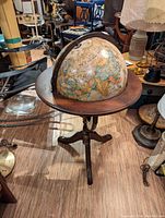 Front view of floor globe on wooden tripod stand