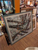 Photo showing the large original abstract painting leaning against a cabinet in a room with various other decorative items.