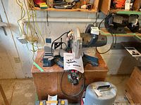 Front view of Bosch sliding miter saw on workbench with instruction manual visible