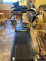 Full view of treadmill showing belt, handrails, console and frame