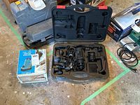 Overall view of the Craftsman rotary trim cutter in black molded case alongside Water Wizard pump box and manual.