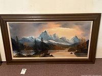 Frontal view of the framed landscape painting showing the whole image, frame and signed corner.