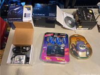 Overview of six camera boxes and three boxed cameras on table